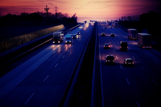 vehicles driving down a highway at night