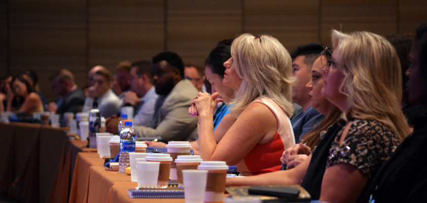 People at a presentation all lined up at a table